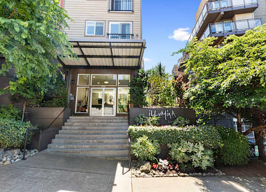 Property Entrance stairs with bushes surrounding the front of it  at Illumina Apartment Homes, WA 98102