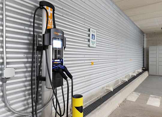 An EV charger in front of a metal wall at Villaggio Apartment Homes, Washington, 98402