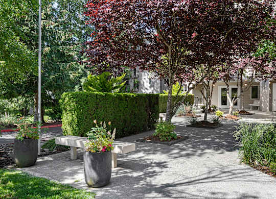Property Courtyard with benches and planters in front for resident enjoyment at West Mall Place Apartment Homes, Everett, WA, 98208