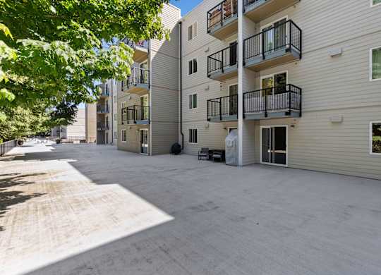 an empty parking lot in front of property building at West Mall Place Apartment Homes, Everett, 98208