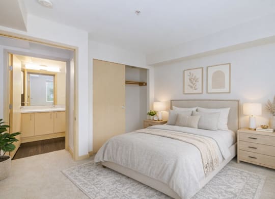 A bedroom with a large bed, a dresser, and a mirror.