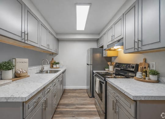 A kitchen with marble countertops and stainless steel appliances.