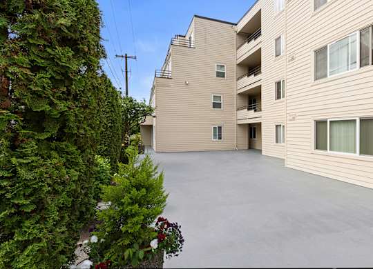 Outdoor Deck Area with Potted Flowers and smooth paving at Hill Crest Apartment Homes, Washington, 98126