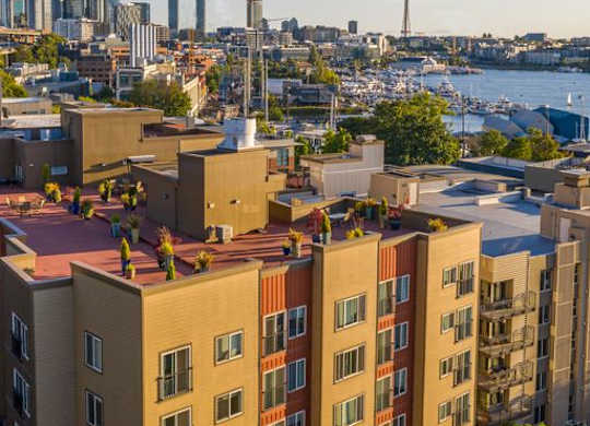 View from the Resident Rooftop Deck of a Puget Sound and the city of Seattle in the background at Illumina Apartment Homes, Washington, 98102