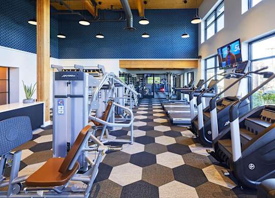 A gym with treadmills and exercise equipment.at Postmark Apartments, Shoreline