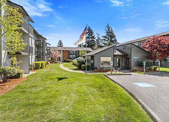 Grassy Courtyard Area with grass and Tress Outlining the Area at Pacific Park Apartment Homes, Edmonds, Washington 98026