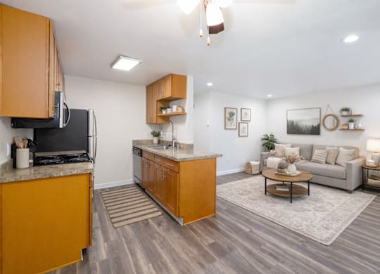 A kitchen with wooden cabinets and a white wall.