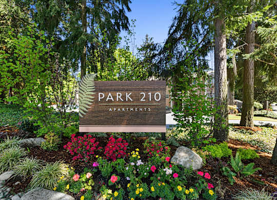 Park 201 Welcome Sign with Expertly Manicured Flowers and Trees at Park 210 Apartment Homes, Edmonds, Washington
