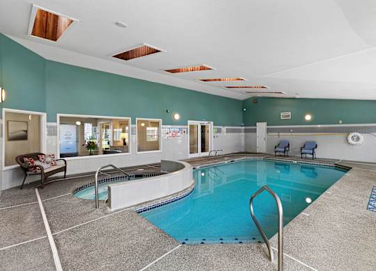 blue indoor swimming pool with a spacious hot tub at Serra Vista Apartment Homes, Washington