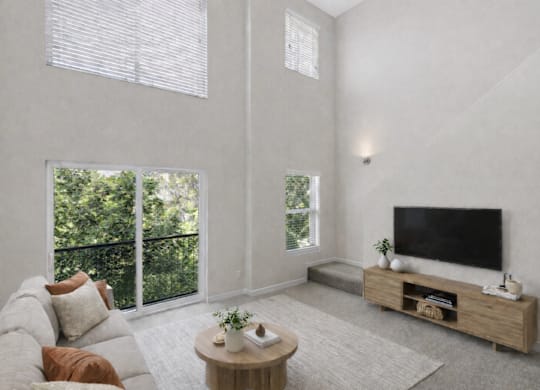 A living room with a grey couch, a wooden coffee table, and a flat screen TV.