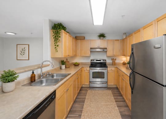 A kitchen with wooden cabinets and a black refrigerator.