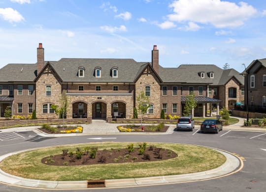 a large brick building with two chimneys and a roundabout in front of it at Griffin Weston, North Carolina, 27513