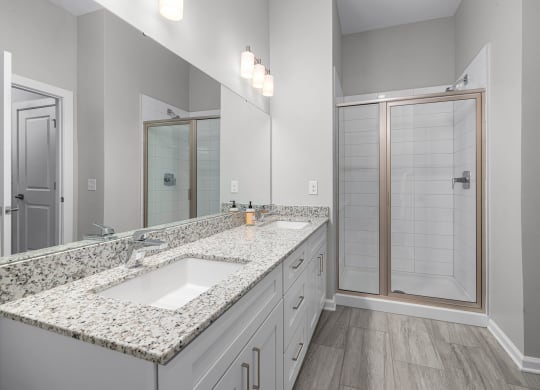 a bathroom with a large mirror and a shower with a glass door  at Griffin Weston, North Carolina