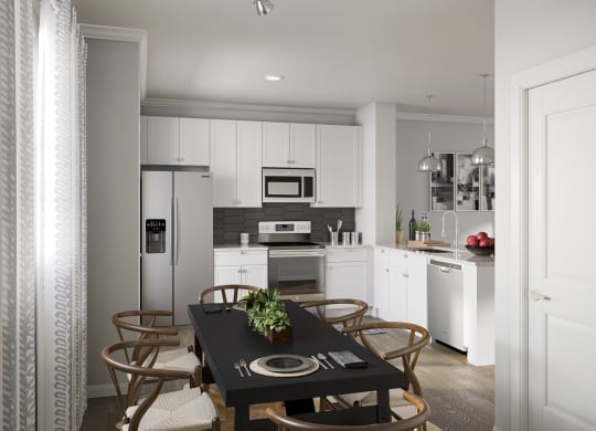 Townhome kitchen with stainless steel appliances, dining area, and granite countertops  at Griffin Weston, Cary