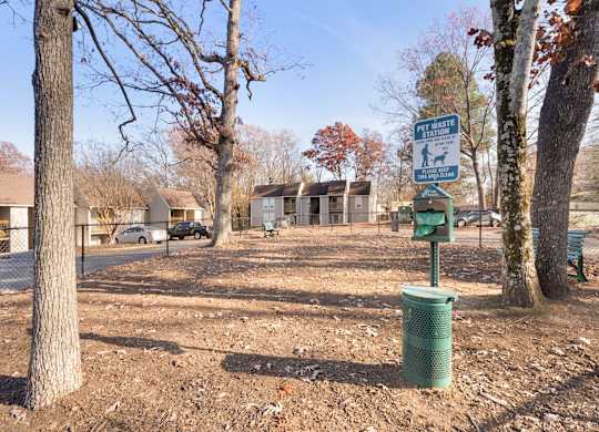 A sign in a park indicates a pet-friendly area at Lakes Edge Apartments, Greensboro, North Carolina