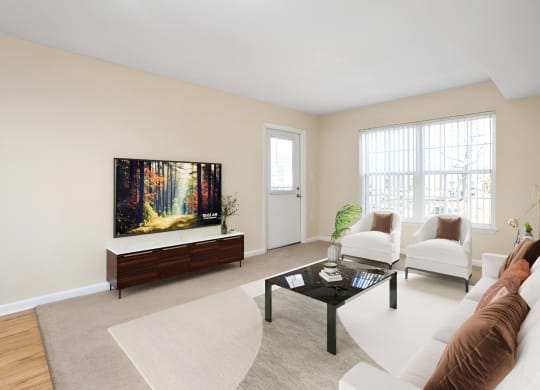 a living room with a couch and a coffee table at West Pointe Apartments in Burlington, NC
