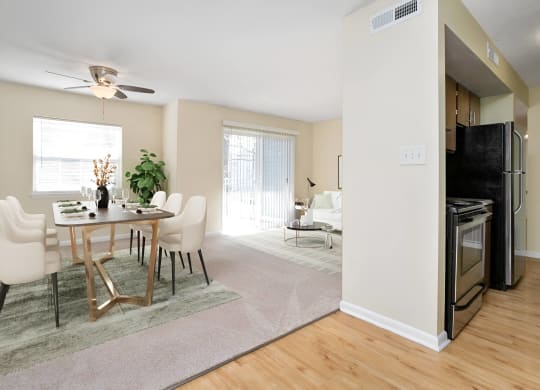 an open living room and dining room with a table and chairs at West Pointe Apartments in Burlington, NC
