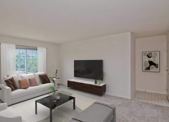 A living room with a white couch, a black television, and a coffee table.