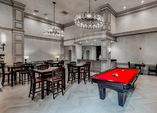 a red pool table in a large room with tables and chairs at The Mark at Dulles Station, Herndon