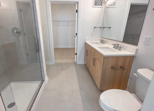 a small bathroom with a shower sink and toilet