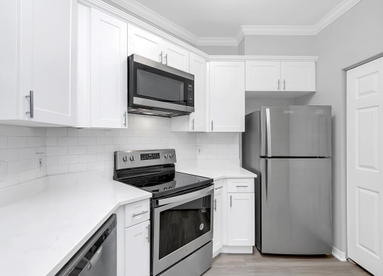 a kitchen with white cabinets and stainless steel appliances at Northlake Park, Orlando, FL, 32827
