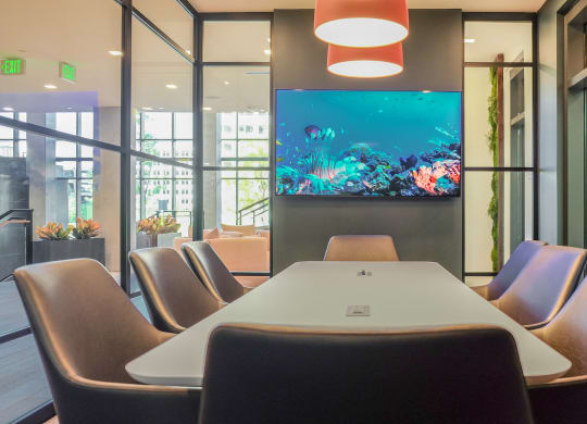 a conference room with a table and a fish tank