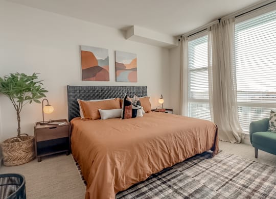 a bedroom with a bed and a chair and a window at Makers Rise, Virginia, 20171