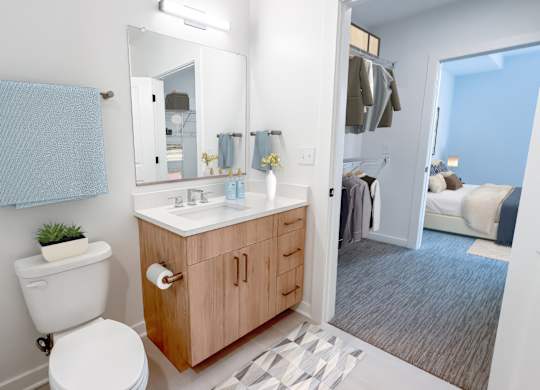 A bathroom with a toilet, sink, and mirror.at Makers Rise, Virginia  