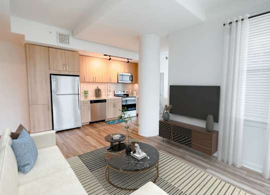 A modern living room with a white sofa and a television.at Makers Rise, Herndon  