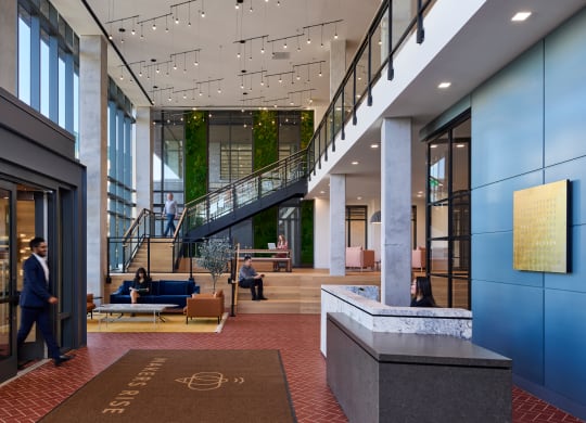 the lobby of a large office building with a lobby area and stairs