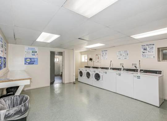 A laundry room with washers and dryers. at Park Georgetown Apartments, Arlington