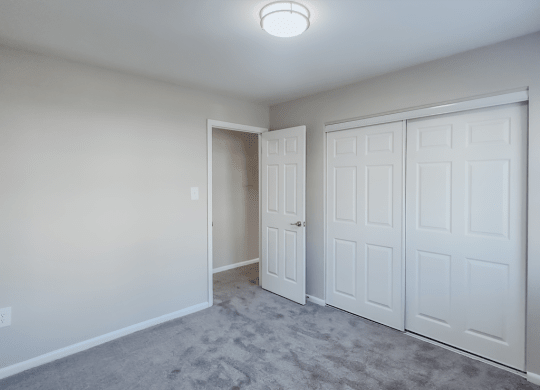 an empty bedroom with two closets and a door to a hallway at Middletown Valley, MD, 21769