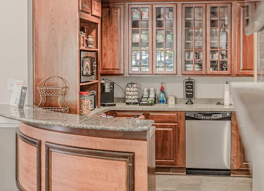 A kitchen with wooden cabinets and a granite counter.