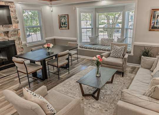 A living room with a fireplace and a dining table.
