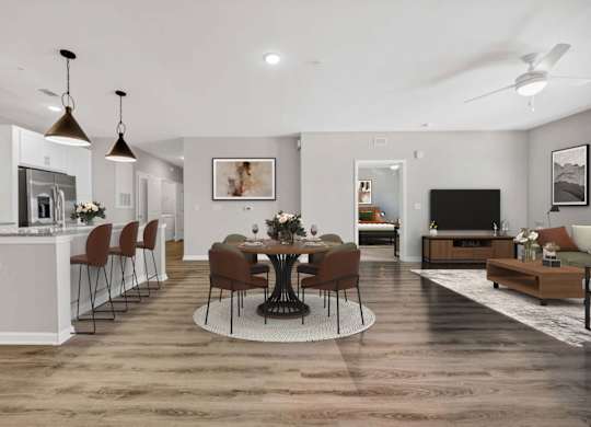 A modern kitchen with a dining table set in the middle.