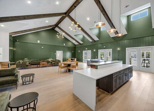 A modern kitchen with a white island and dark wood floors.