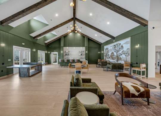 A large room with a green wall and a wooden floor.