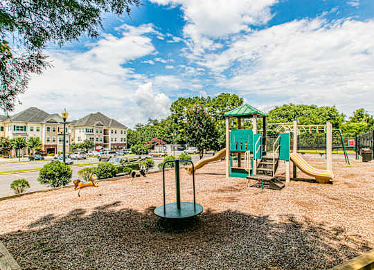 A playground with a green slide and a yellow slide. at Barrington Park Apartments, Manassas, VA, 20110