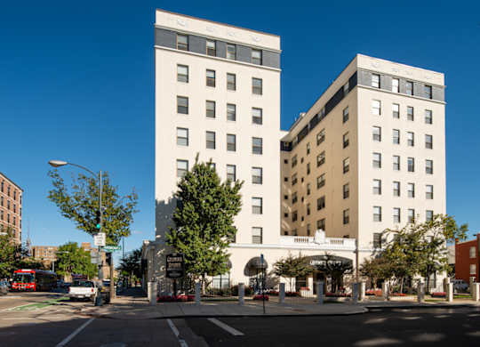 Two white buildings stand next to each other on a street corner. at Columbia Uptown Apartments, Washington, Washington DC