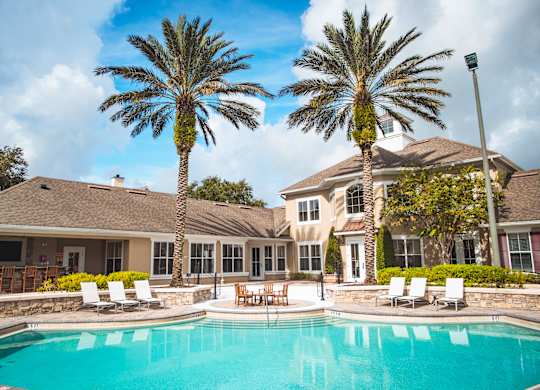 A large house with a pool in front of it.