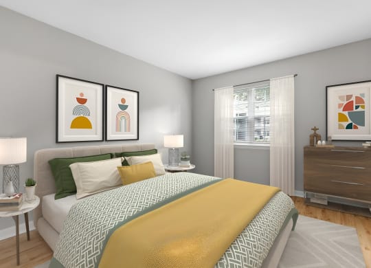 a bedroom with a bed and pictures on the wall at West Pointe Apartments in Burlington, NC