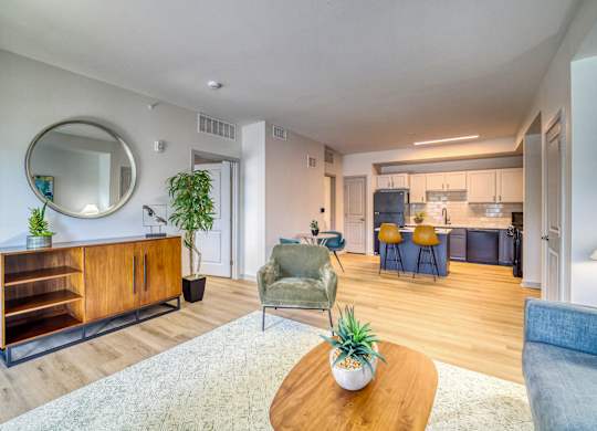 A living room with a wooden coffee table and a green armchair.