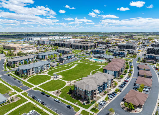 an aerial view of a city with buildings and a green park at Arbour Commons, Colorado, 80023