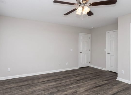 A room with a ceiling fan and wooden flooring at Diamond Townhomes, Beaufort