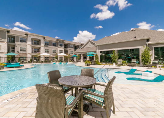 Poolside Dining Table at Cue Luxury Apartments, Cypress, TX, 77433