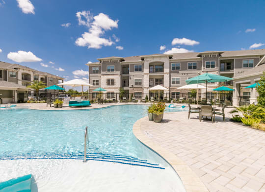 Relaxing Pool Area With Sundeck at Cue Luxury Apartments, Cypress