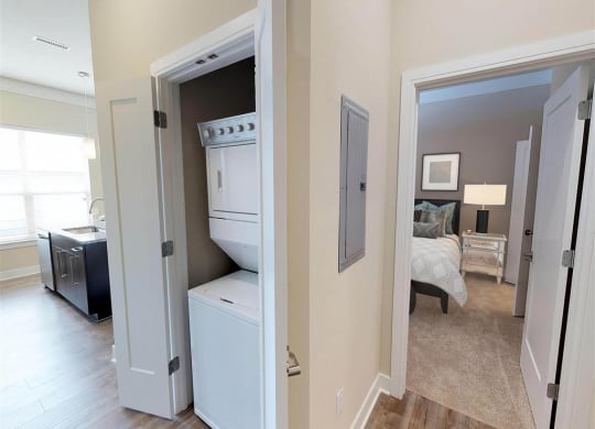 a view of a bedroom with a closet and a laundry room