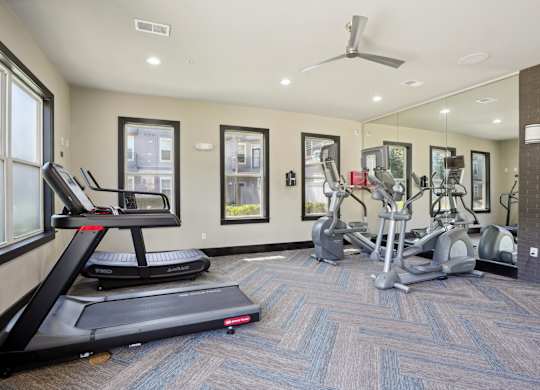 Fitness center with treadmills and elliptical machines at Highline Urban Lofts Apartments, Cypress, 77429