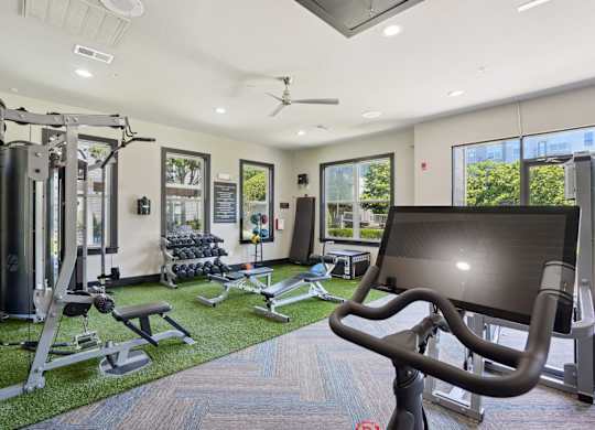 Gym with cable machines and artificial turf flooring at Highline Urban Lofts Apartments, Texas