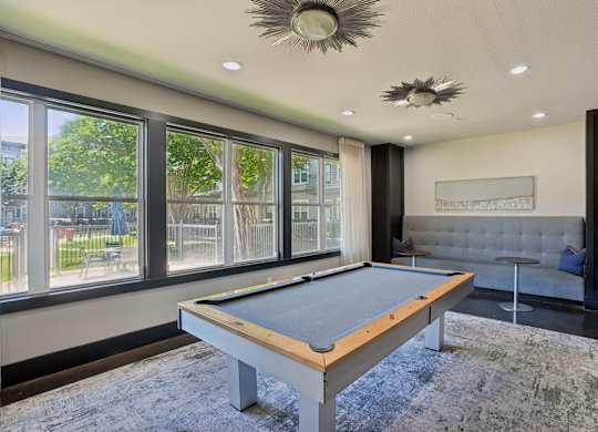 Recreation room with pool table and lounge seating at Highline Urban Lofts Apartments, Cypress, TX